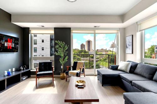 a living room with a couch and a table at E501 Spacious & Stylish 2bedroom Condo In Downtown Minneapolis, Minutes From Minneapolis Convention Center & US Bank Arena in Minneapolis