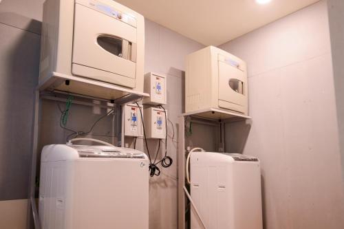 a room with two refrigerators and boxes on the wall at KIWI-Taichung Station Branch 1 in Taichung