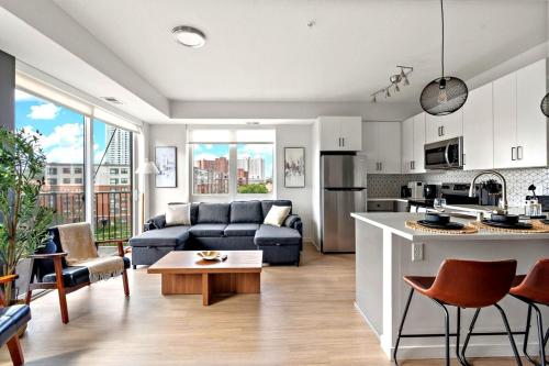a kitchen and living room with a couch and a table at E501 Spacious & Stylish 2bedroom Condo In Downtown Minneapolis, Minutes From Minneapolis Convention Center & US Bank Arena in Minneapolis