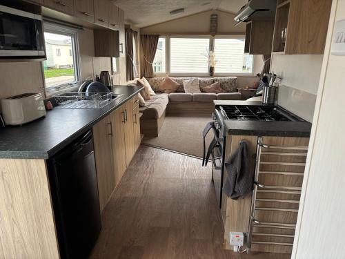 a kitchen and living room of an rv at Luxury Hot tub breaks at Sunnymede, Ingoldmells in Ingoldmells