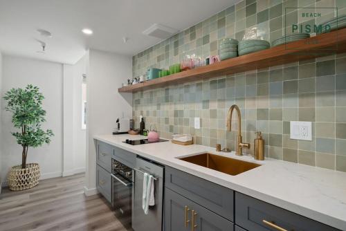 a kitchen with a sink and a counter top at Pismo Beach Club in Pismo Beach