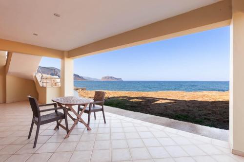 a patio with a table and chairs and the ocean at Ground Floor Studio by the sea in Monemvasia