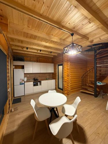 a kitchen and dining room with a table and chairs at Лесник in Cholpon-Ata