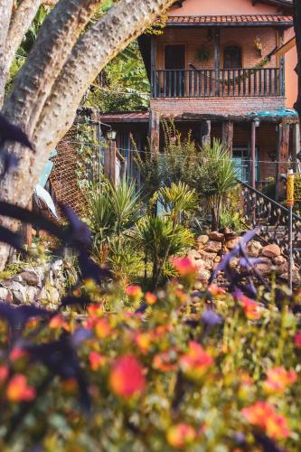 a garden with flowers in front of a house at Pousada Bosque das Borboletas in Sabará