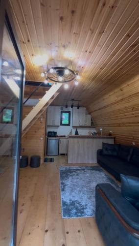a living room with a couch and a table at Lunea Cottage in Itʼkhvisi
