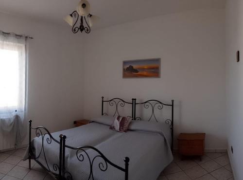 a bedroom with a bed in a white room at Finestra su Velia in Marina di Ascea