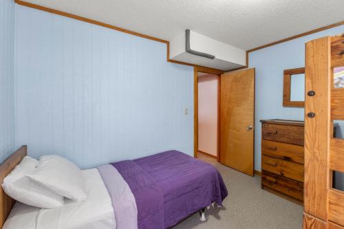a bedroom with a bed and a dresser in it at Brass Ring in Sanderling