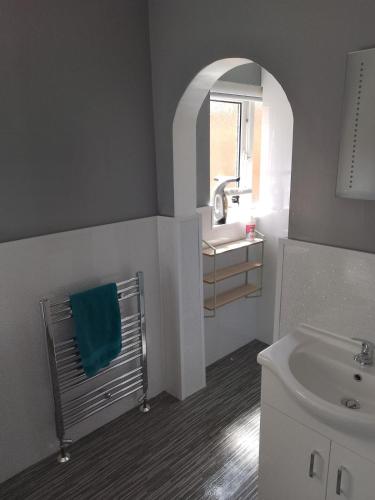 a bathroom with a sink and a toilet and a mirror at Studio Twenty One in Whitburn