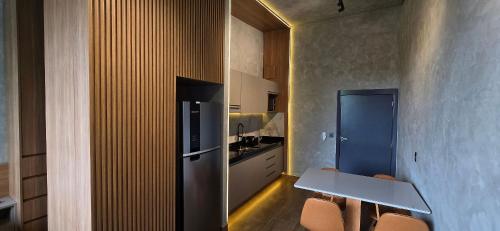 a kitchen with a table and chairs in a room at City Zen Studios in Sao Jose do Rio Preto