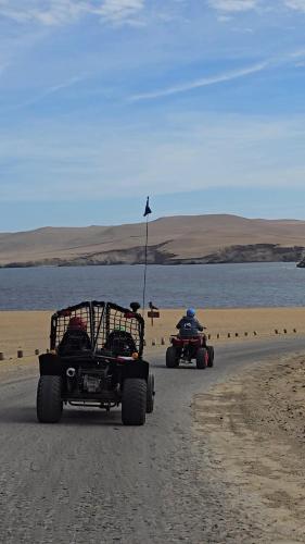 two people riding on atvs on a beach at Hotel Riviera Inka Paracas in Paracas