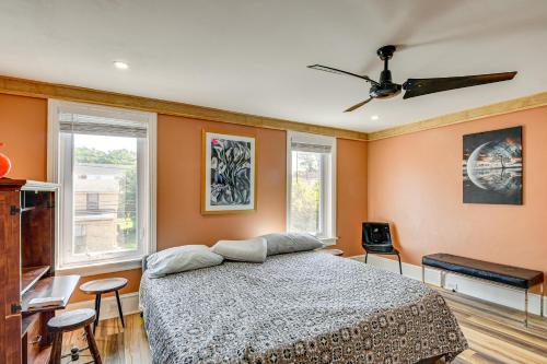 a bedroom with a bed and two windows at Walkable Neighborhood Updated Morton Home! 