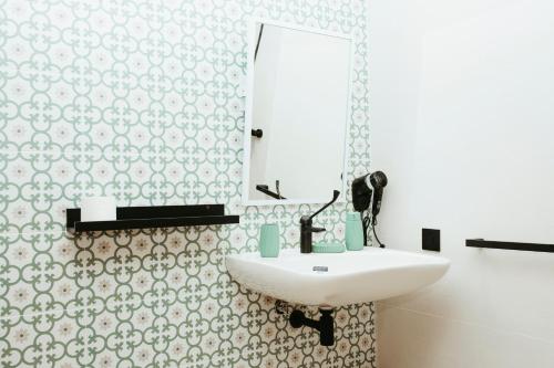 a bathroom with a sink and a mirror at Hostal Ainhoa in Tafalla