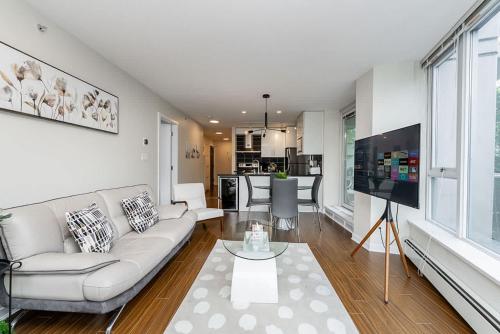 a living room with a couch and a table at Spacious Downtown Condo with Pool Gym & Parking in Vancouver