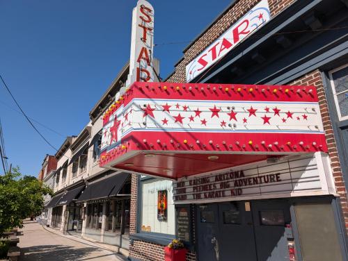 a theater with a red and white marquee on a street at Ma-ple Haven --Wifi, Fireplace, Deck, Fire Pit, Family Friendly, Game Room, Pool Access in Berkeley Springs