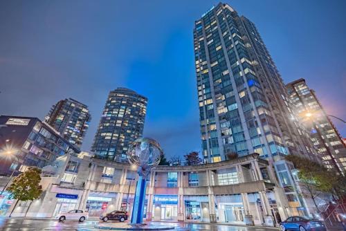 a large building with tall buildings in a city at Downtown Condo with Great City Views in Vancouver