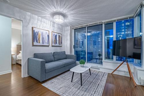 a living room with a couch and a flat screen tv at Downtown Condo with Great City Views in Vancouver