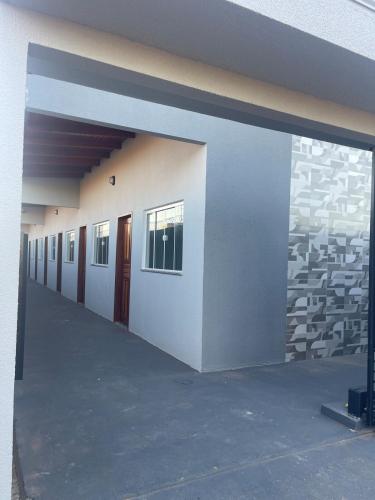 an empty hallway of a building with doors and windows at VivaVida boungavilli 01 in Sinop