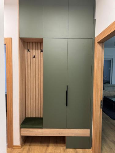 a cabinet with a glass door in a room at Modi II in Skopje