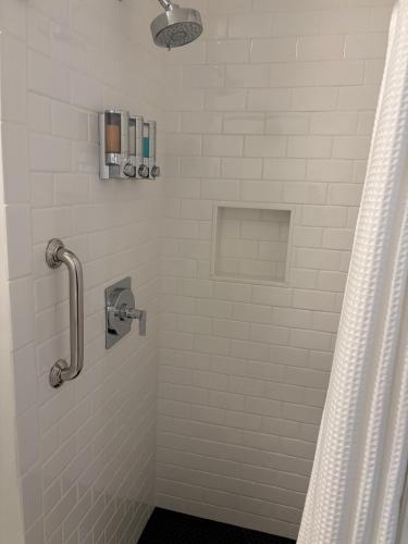 a bathroom with a shower with a shower curtain at The Harbor Inn in Kennebunkport