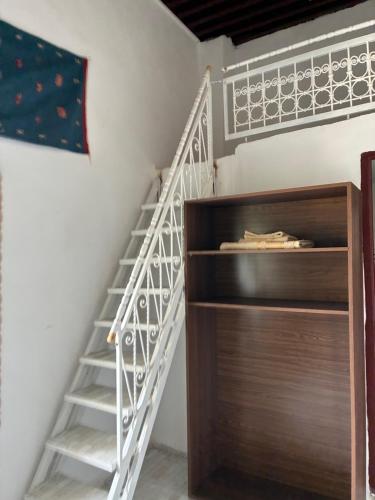 a staircase in a room with a wooden cabinet at Riad Serendipity in Fès