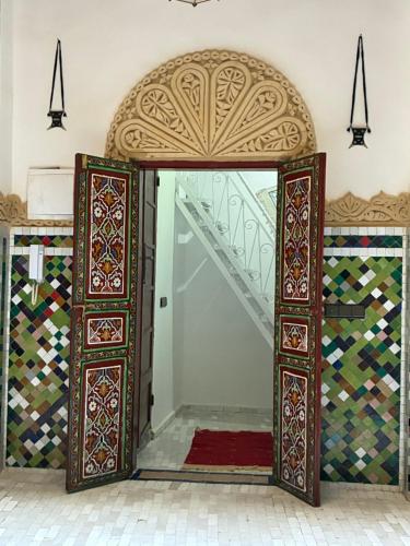 an entrance to a room with an ornate doorway at Riad Serendipity in Fès