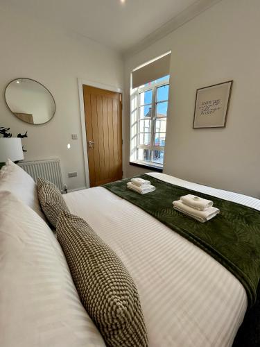 a bedroom with a large bed with towels on it at Apartment - Poole High Street in Poole