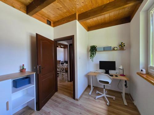 a home office with a desk and a computer at ChillForest SPA in Tomczyn