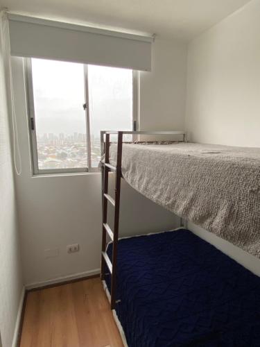 a bunk bed in a room with a window at Departamento completo 2 dormitorios 1208 cercano movistar arenas in Santiago