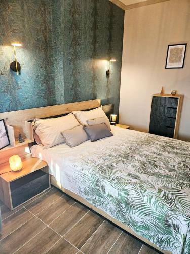 a bedroom with a large bed and a wooden floor at Blue Apartment Kamelia in Durrës
