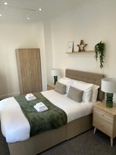 a bedroom with a large bed with white sheets and pillows at Apartment - Poole High Street in Poole