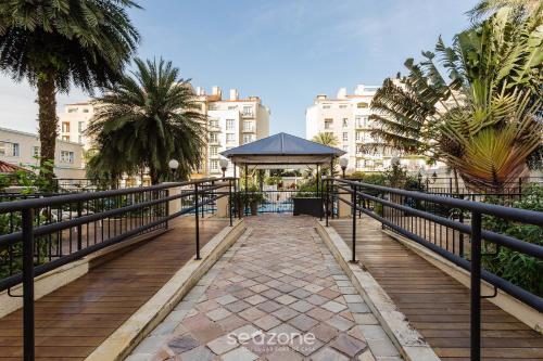 a boardwalk with a gazebo in a city at Studios frente ao mar no IL Campanario Resort ILCTOP in Florianópolis