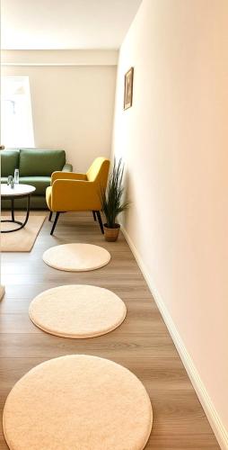 a living room with circular rugs on the floor at Neubauwohnung in Siegen-Zentrum in Siegen