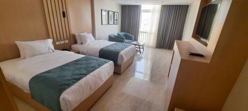 a hotel room with two beds and a television at فندق أورو بلازا ORO Plaza Hotel in Cairo