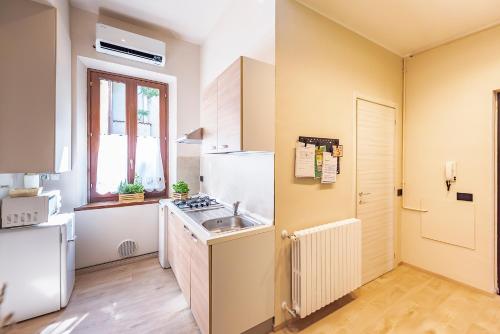 a kitchen with a sink and a refrigerator at La rosa dei venti in Legnano