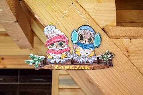 a sign with two owls on a wooden wall at Borje Mountain Chalet near Durmitor & Žabljak in Borje