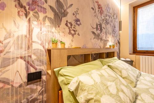 a bedroom with a bed and a floral wall at La rosa dei venti in Legnano
