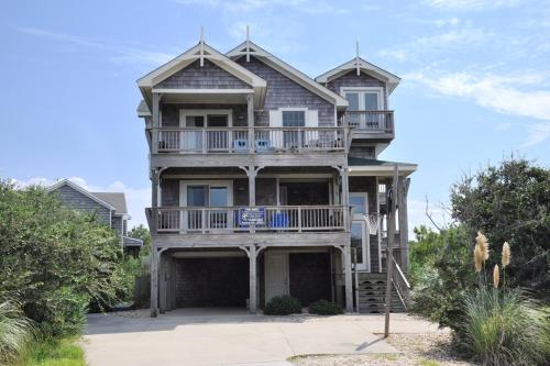 a large house with a balcony on top of it at Curlews Call in Nags Head