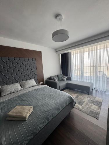 a bedroom with a large bed and a couch at Grand Sapphire Casino studio 20 in Iskele