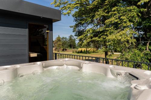 a jacuzzi tub in a backyard with a view at Balaton Flow Residence in Fonyód