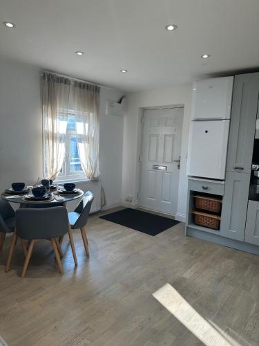 a kitchen and dining room with a table and chairs at The Hideaway Haven in Belvedere