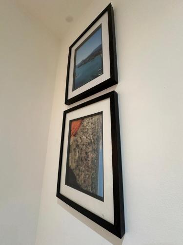 two framed pictures are hanging on a wall at The Hideaway Haven in Belvedere