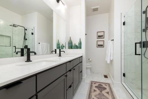 a white bathroom with a sink and a shower at Brand NEW Townhome! Luxury AND Convenience - NO EXTRA FEES! in Grand Junction