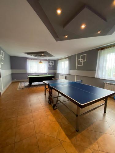 a large room with a ping pong table in it at Noclegi Pod Lasem in Zubrzyca Górna