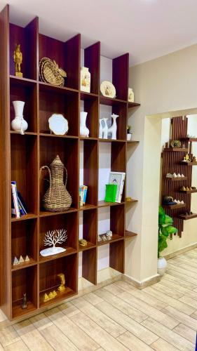 a book shelf with vases and other items on it at Casablanca Hotel in Cairo