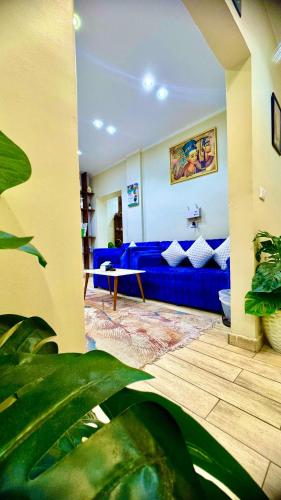 a living room with a blue couch in a room at Casablanca Hotel in Cairo
