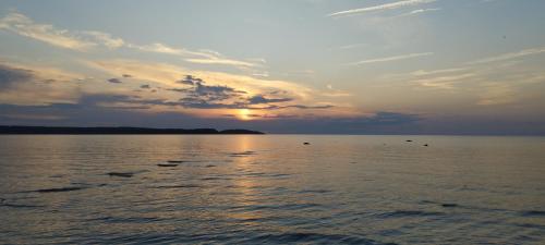a sunset over a large body of water at Merelahe 
