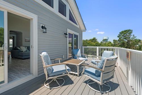a patio with chairs and a table on a deck at Driftwood in Duck
