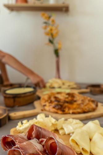 a table with a pizza and other food on it at Apartment Vila Jela in Kolašin