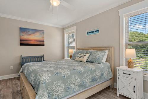 a bedroom with a bed and a window at Driftwood in Duck