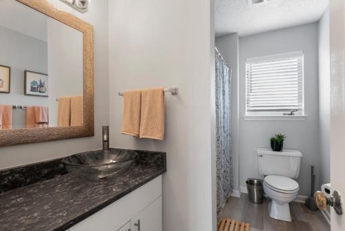 a bathroom with a sink and a toilet at Duck Crossing in Manteo